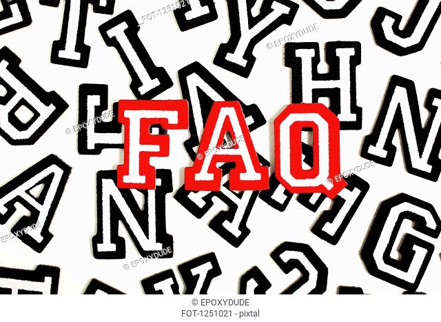 Red outlined varsity font stickers spelling FAQ on top of black outlined letters