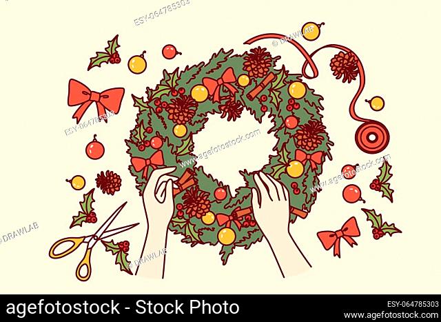 Diy christmas wreath made from green fir branches and red bows or pine cones for interior decoration. Process of making christmas wine to prepare for new year...