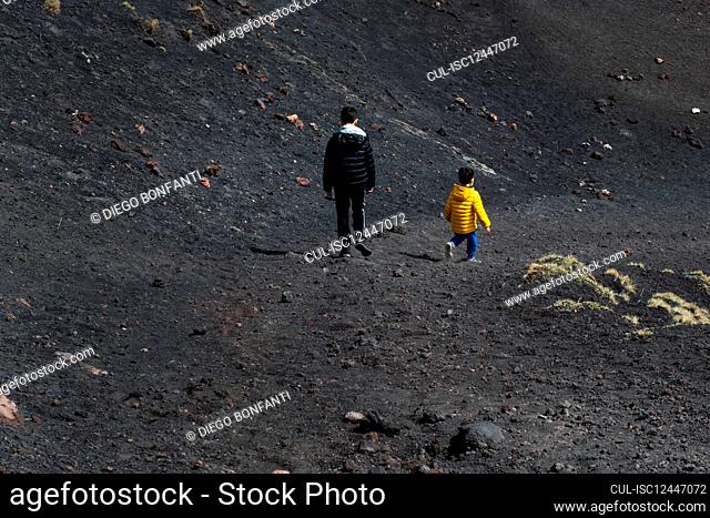 Italy, Sicily, Boys hiking around Etna volcano