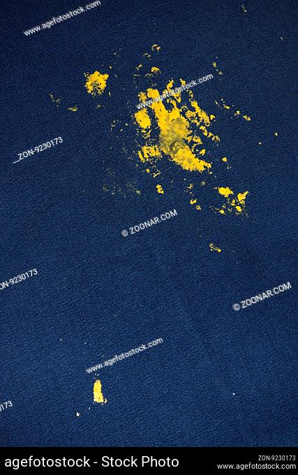 Blue Jeans and sneakers stained with yellow paint