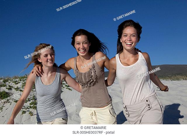 Three girls smiling into camera