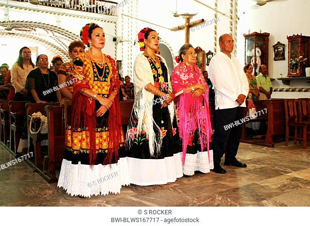 women of Juchitan, the city of the strong women, in costume during a church service, Mexico, Oaxaca, Juchitan