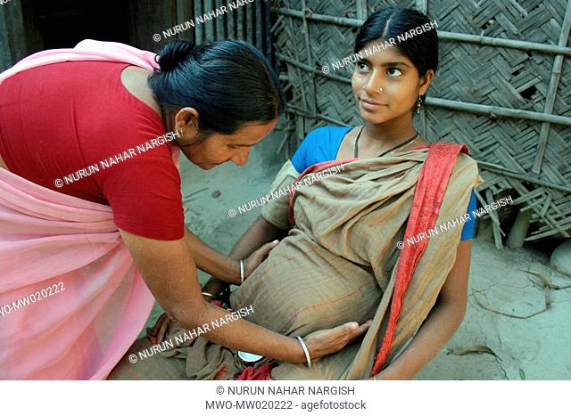 A volunteer health worker of BRAC checking up a pregnant woman, in the village of Nabagram, Manikganj, Bangladesh January 29, 2009
