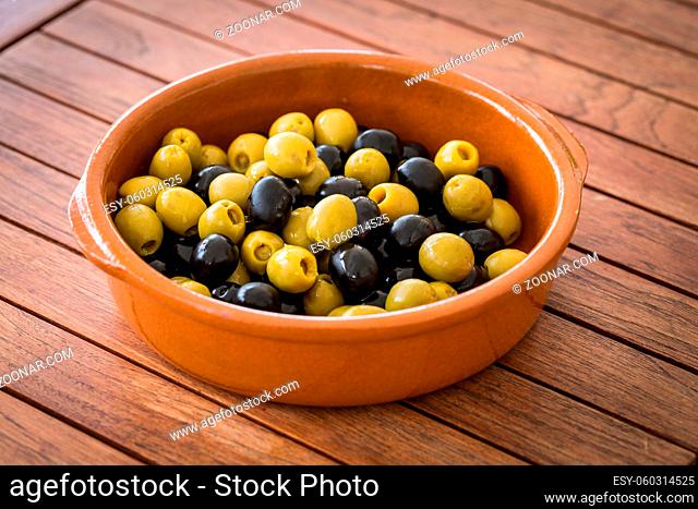 Spanish black and green olives in the bowl