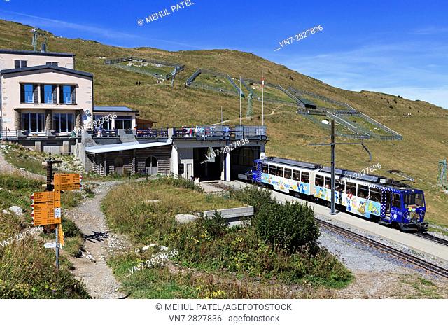 Cog railway train at station of Rochers-de-Naye close to summit of the mountain, Switzerland, Europe. The train arrives from and departs to Montreux by Lake...