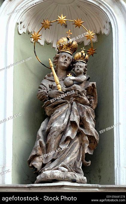 Virgin Mary with baby Jesus, statue on the house facade in Graz, Styria, Austria