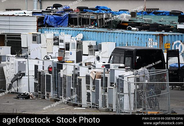 18 April 2023, Hamburg: Refrigerators and other electrical appliances are stored behind the fence of a commercial enterprise