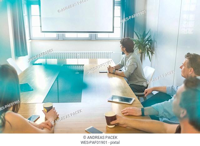Business people sitting at conference table in office