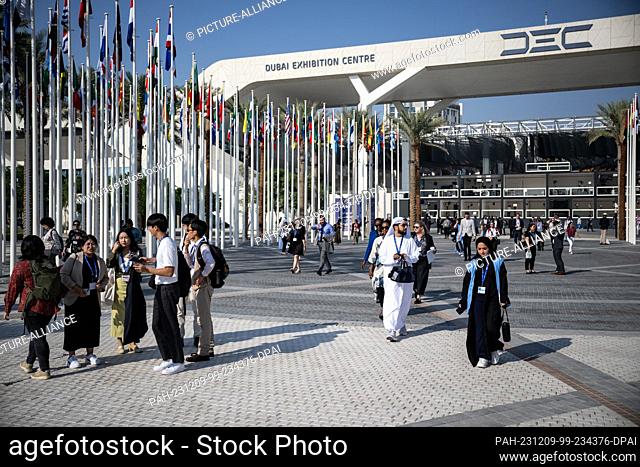 09 December 2023, United Arab Emirates, Dubai: People walk over the railings at COP28 in Dubai. The main topics at this year's UN Climate Change Conference...