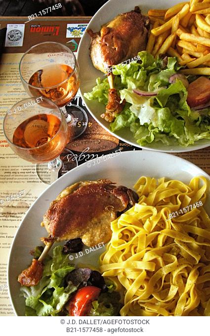 Food: 'Confit de canard' with French fries or pasta, rosé wine and salad, Lot, Midi-Pyrenees, France