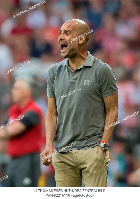 Manchester's head coach Pep Guardiola reacts during an international soccer friendly match between FC Bayern Munich and Manchester City at the Allianz Arena in...