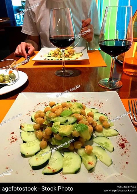 Salad made of avocado, chickpeas, cucumber and olive oil