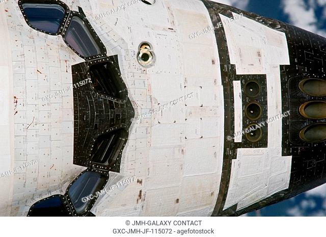 This close-up view of the crew cabin of space shuttle Discovery was provided by an Expedition 26 crew member during a survey of the approaching STS-133 vehicle...