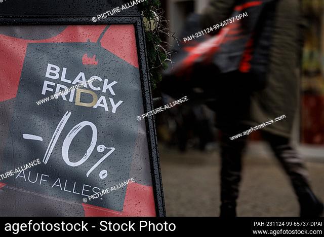 24 November 2023, Lower Saxony, Osnabrück: ""Black Friday"" can be seen on a poster outside a store. Numerous stores and online stores celebrate Black Friday...
