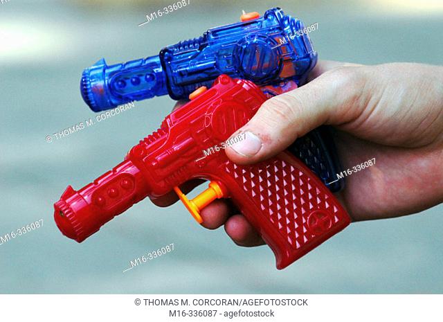 Two water guns in a hand