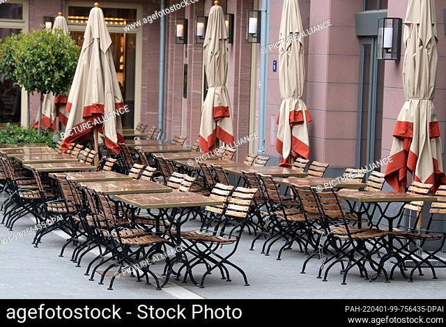 01 April 2022, Hessen, Frankfurt/Main: Empty tables and chairs outside a restaurant in Frankfurt am Main. Over the weekend
