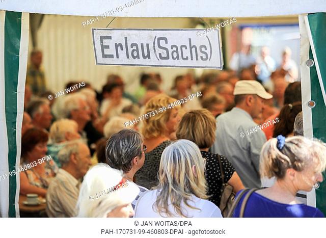 Numerous visitors stand inside the beer tent during the opening of the 'Generationenbahnhof' (lit. generation train station) in Erlau, Germany, 31 July 2017