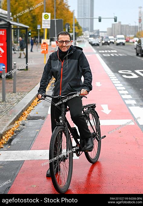 26 October 2020, Berlin: Stephan von Dassel (Bündnis 90/Die Grüne), district mayor of Berlin Mitte, rides his bicycle on the newly designed Karl-Marx-Allee with...
