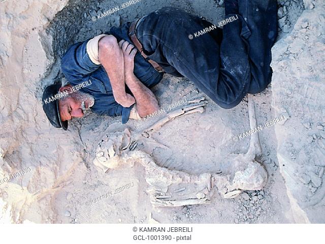 Elderly man sleeping at the archaeological site of Shahr-e-Soukhteh, Sistan province, Iran