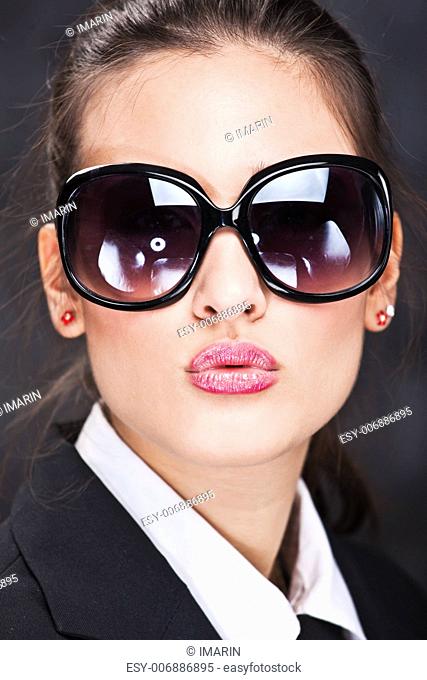 Pretty girl with big sun glasses sending kiss