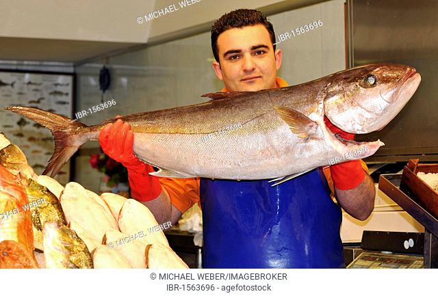 Fish vendor proudly presenting a fish, market quarter, market halls, Thessaloniki, Chalkidiki, Macedonia, Greece, Europe