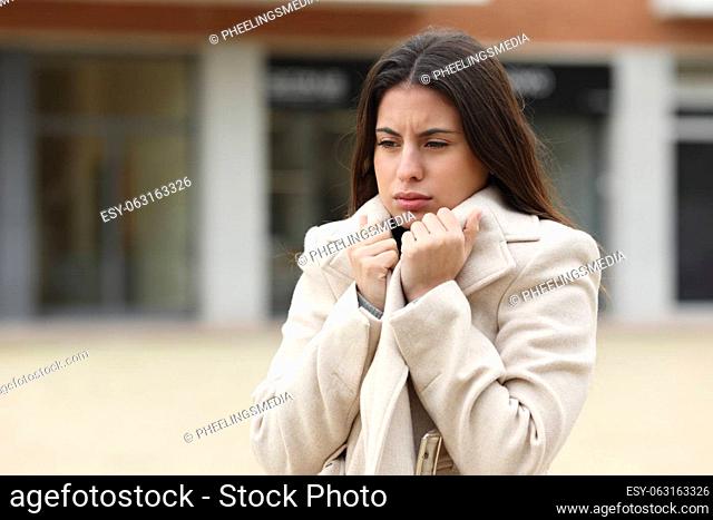 Woman getting cold walking in the street in winter