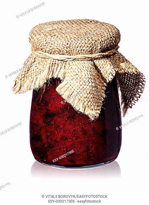 Currant jam in jar with burlap isolated on white background