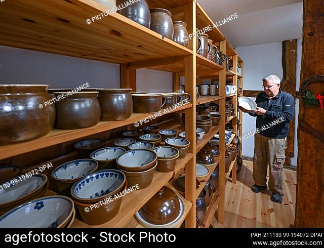 26 November 2021, Brandenburg, Groß Neuendorf: Manfred Dannegger, potter, stands in his salesroom. He is one of the last brownware potters in Germany