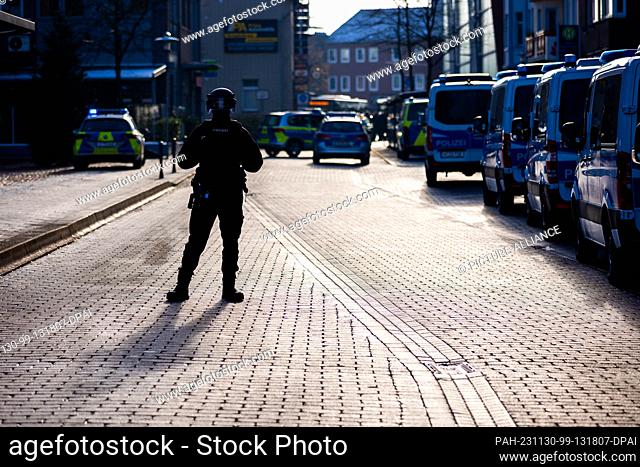 30 November 2023, Lower Saxony, Lehrte: Police vehicles are parked in front of a job center near the train station. The police have arrested a suspect who is...