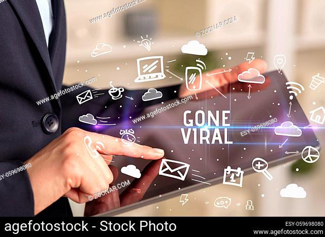 Close-up Of A Person Using Social Networking with GONE VIRAL inscription