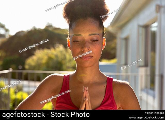 Portrait of mixed race woman exercising practicing yoga on a terrace