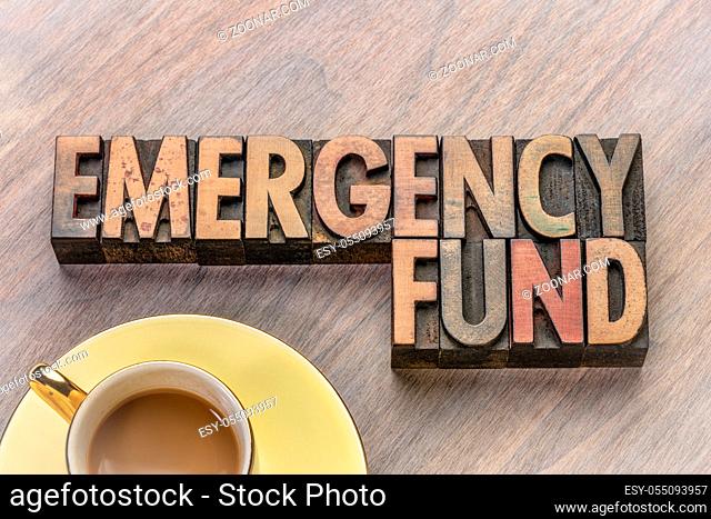 emergency fund word abstract in vintage letterpress wood type with a cup of coffee
