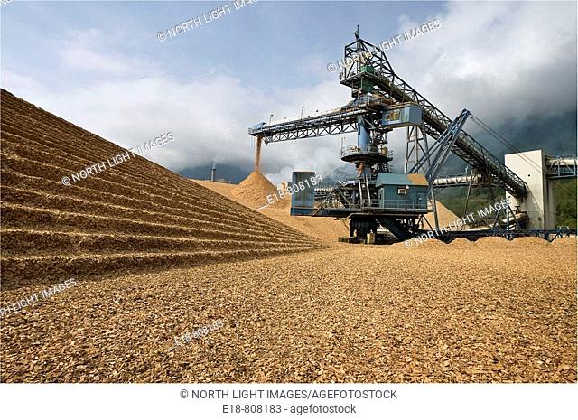 Canada, BC, Port Mellon.  Wood chip pile and conveyor at pulp and paper mill