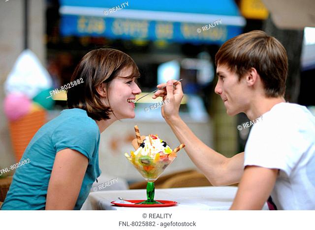 Young couple is eating ice-cream together