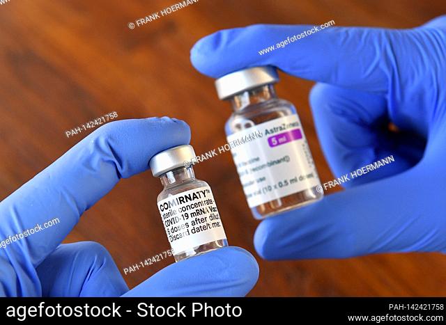 Topic picture - Comirnaty vaccine from BionTech and AstraZeneca Corona vaccine. Vaccine doses with vaccine for injection with a cannula. Close up