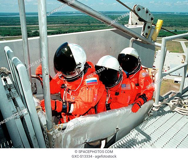 04/29/1999 --- STS-96 Mission Specialists left to right Valery Ivanovich Tokarev, Julie Payette and Ellen Ochoa Ph.D. wait in the slidewire basket at Launch Pad...