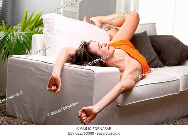 girl yawning and stretching on her sofa