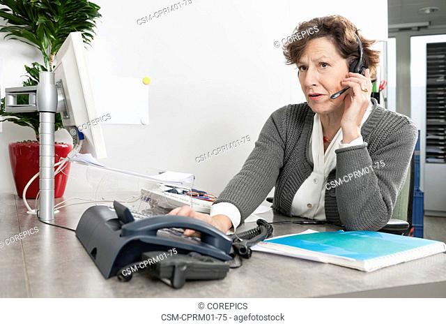 Call center employee listening attentively to the question asked by a caller