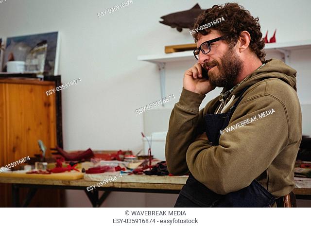 Craftsman talking on mobile phone