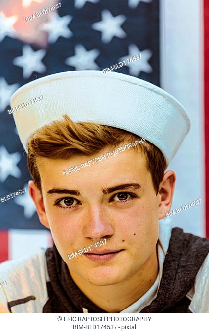 Caucasian teenage boy wearing sailor hat