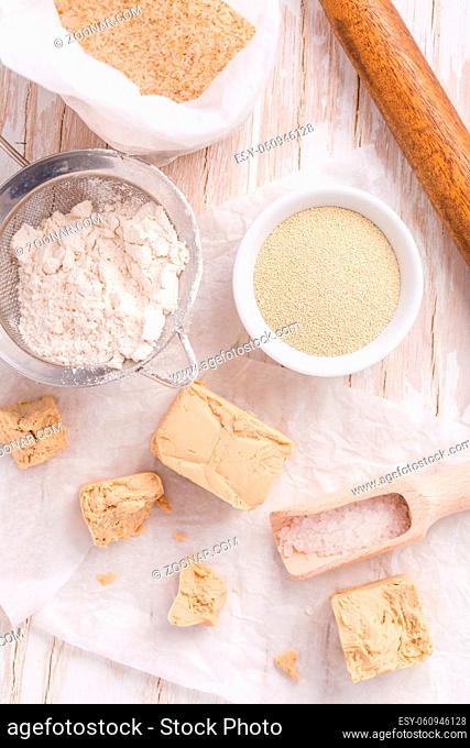 Fresh and dried yeast with baking ingredients on white background