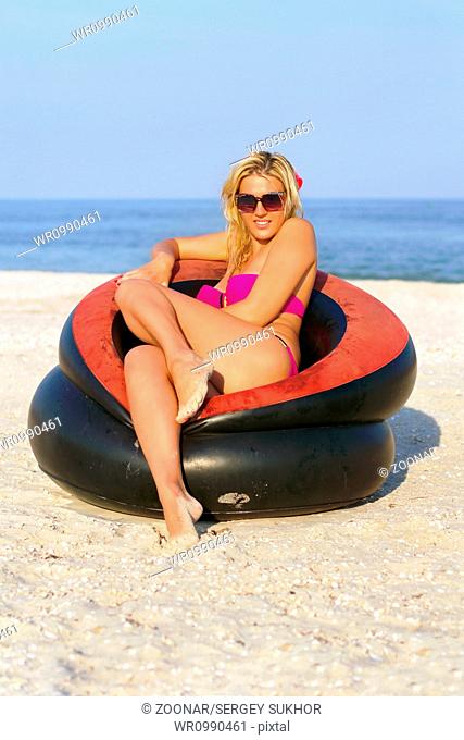 Beautiful girl sitting in an inflatable chair