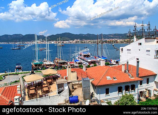 MUGLA, TURKEY - JUNE 1, 2015 : Top view of Marmaris Marina among mountains with sailing boats and yatches anchored, on blue sky background