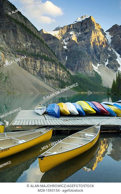 Colorful canoes on dock of Moraine Lake, Banff National Park Alberta Canada