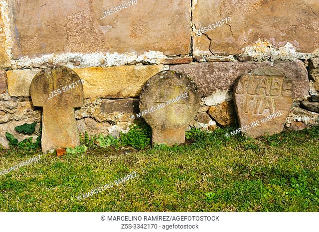 Remains of an ancient cemetery with discoid steles. courtyard of Church of the Assumption, Etxalar, Cinco Villas, Bortziriak, Navarre, Spain, Europe