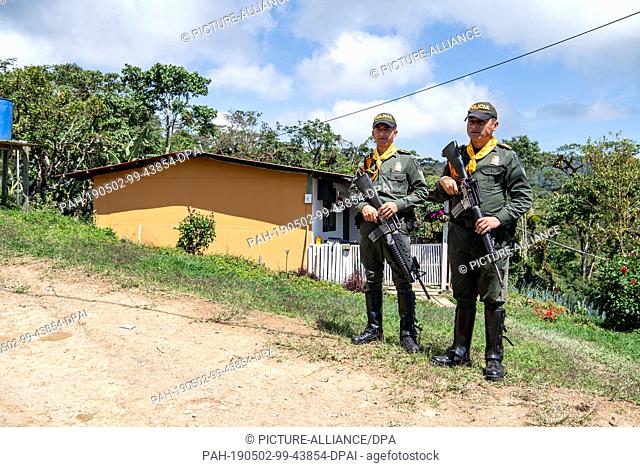 01 May 2019, Colombia, Icononzo: Two Colombian soldiers are standing in the reintegration camp (ECTR) of former FARC combatants in Icononzo in the state of...