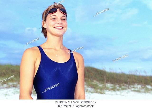 Woman with Swimsuit and Goggles on Beach Smiling