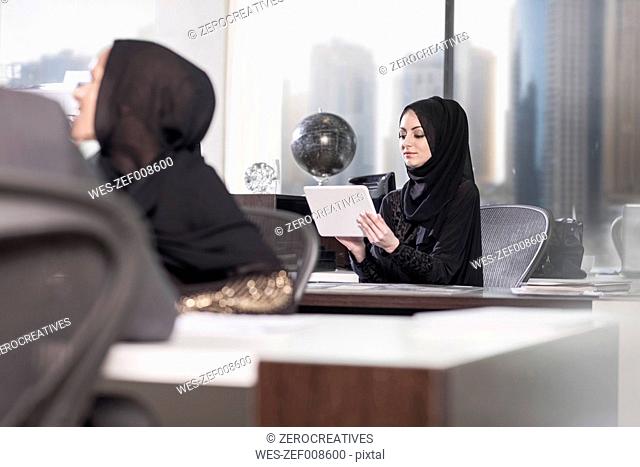 Middle Eastern businesswomen working in office