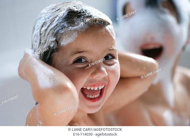 Young girl in bath washing hair