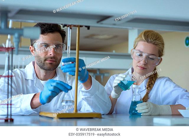University students doing a chemical experiment in laboratory